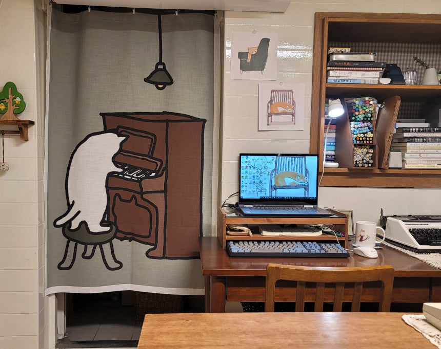 A cat playing the piano (fabric curtain)