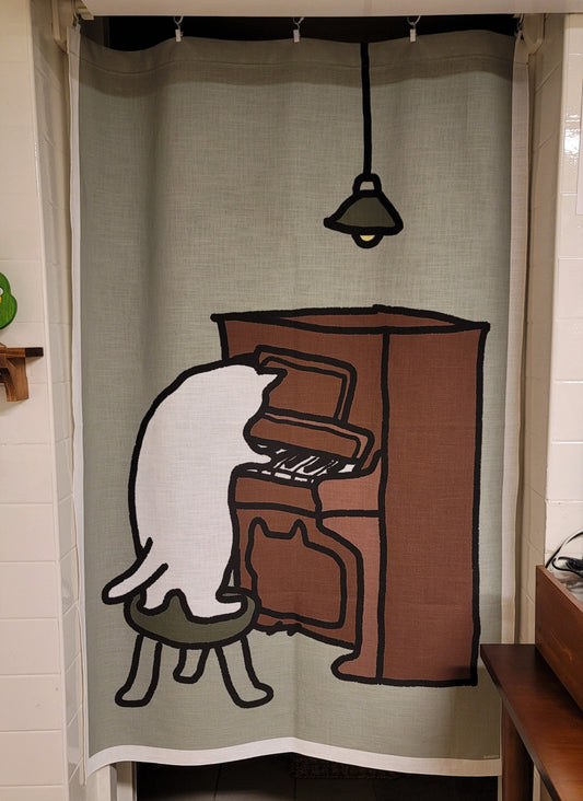A cat playing the piano (fabric curtain)